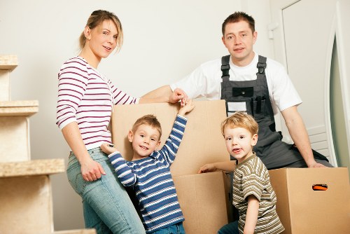 Packed moving boxes and furniture ready for transport in Edgware
