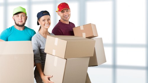 Removal team handling furniture and boxes during a home move in Edgware