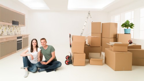 Packed moving boxes and furniture ready for transport in Edgware