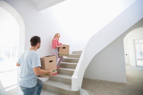 Removal van and moving team handling furniture in Edgware