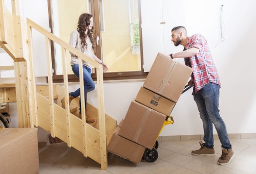 Moving boxes and furniture being loaded carefully for a local removal service